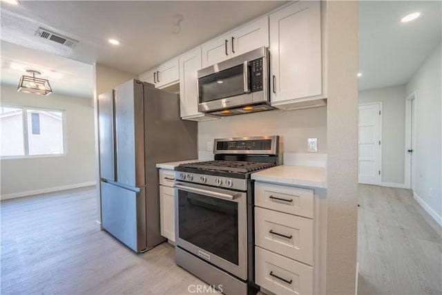 5187 Cedar St, Jurupa Valley, CA 92509 - kitchen featuring stainless steel appliances, light wood finished floors, white cabinetry, and recessed lighting