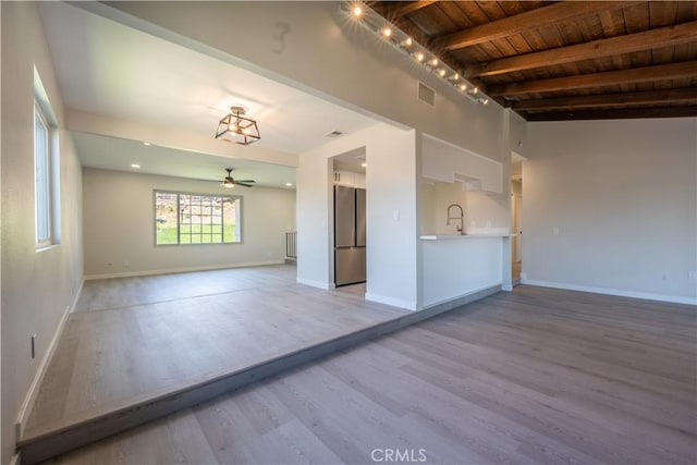 5187 Cedar St, Jurupa Valley, CA 92509 - unfurnished living room featuring a wooden ceiling with exposed beams, light wood-type flooring, ceiling fan, and radiator