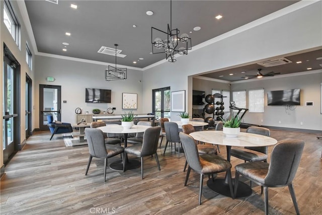 660 Daniel Freeman Cir, Inglewood, CA 90301 - dining space with crown molding, a high ceiling, light wood-type flooring, a chandelier, and baseboards