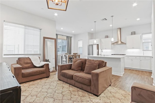 660 Daniel Freeman Cir, Inglewood, CA 90301 - living room featuring light wood-type flooring, recessed lighting, and a chandelier