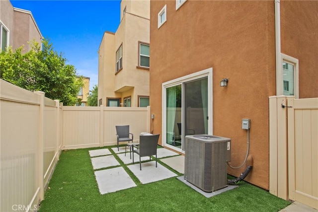 660 Daniel Freeman Cir, Inglewood, CA 90301 - rear view of property with cooling unit, stucco siding, a fenced backyard, and a patio area