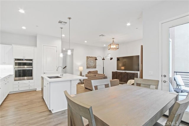 660 Daniel Freeman Cir, Inglewood, CA 90301 - dining area with light wood-style flooring, a chandelier, and recessed lighting