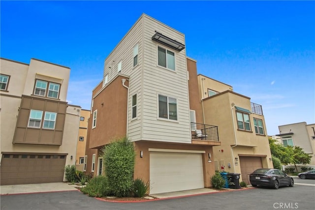 660 Daniel Freeman Cir, Inglewood, CA 90301 - view of front facade with an attached garage, stucco siding, and a balcony