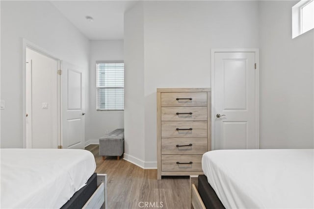 660 Daniel Freeman Cir, Inglewood, CA 90301 - bedroom featuring light wood finished floors, multiple windows, and baseboards
