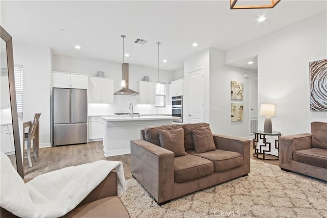 660 Daniel Freeman Cir, Inglewood, CA 90301 - living room with light wood-style flooring and recessed lighting