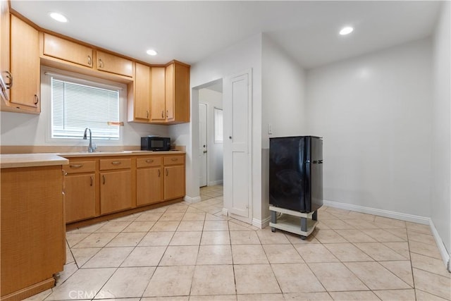 6031 6th Ave, Los Angeles, CA 90043 - kitchen with black appliances, light countertops, baseboards, recessed lighting, and light tile patterned floors