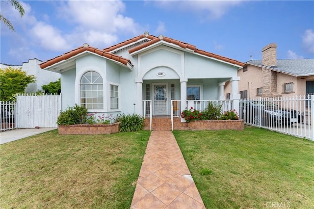 6031 6th Ave, Los Angeles, CA 90043 - mediterranean / spanish-style home featuring covered porch, a tile roof, and stucco siding