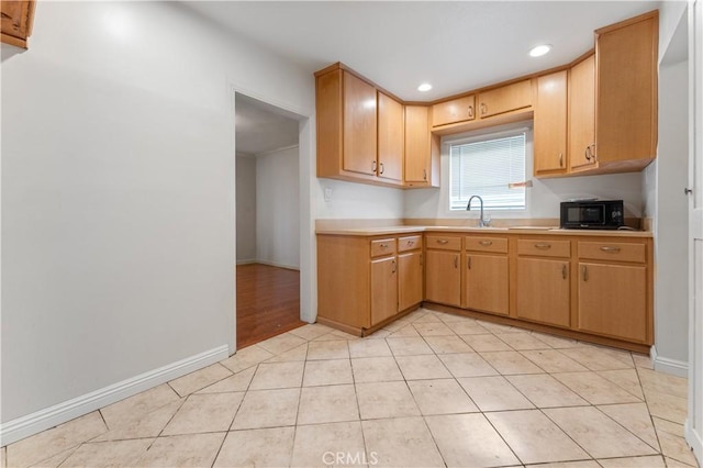 6031 6th Ave, Los Angeles, CA 90043 - kitchen featuring black microwave, light countertops, baseboards, a sink, and recessed lighting