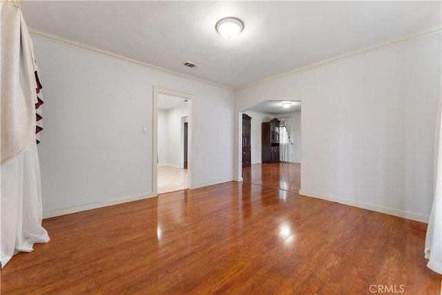 6031 6th Ave, Los Angeles, CA 90043 - empty room with crown molding, wood finished floors, arched walkways, and baseboards
