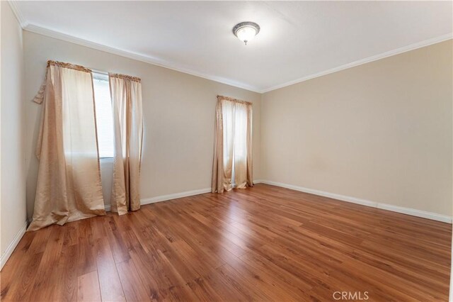 6031 6th Ave, Los Angeles, CA 90043 - empty room with healthy amount of natural light, wood finished floors, ornamental molding, and baseboards