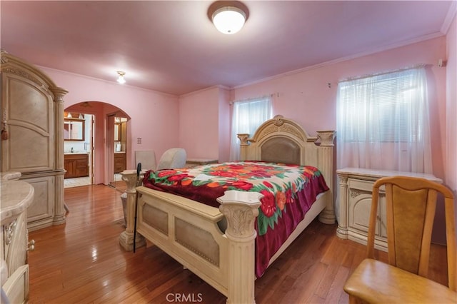6031 6th Ave, Los Angeles, CA 90043 - bedroom with arched walkways, ornamental molding, and light wood-style flooring