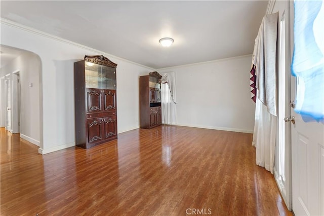 6031 6th Ave, Los Angeles, CA 90043 - spare room with wood finished floors, arched walkways, crown molding, and baseboards