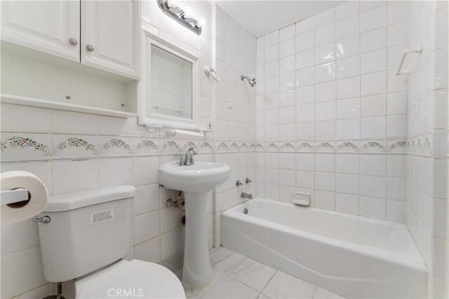 6031 6th Ave, Los Angeles, CA 90043 - full bathroom featuring toilet, bathtub / shower combination, tile walls, a sink, and marble finish flooring