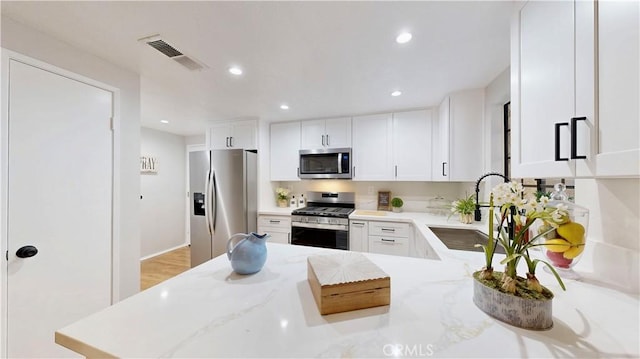 8535 Creekside Pl, Rancho Cucamonga, CA 91730 - kitchen with stainless steel appliances, white cabinets, recessed lighting, light stone countertops, and a sink
