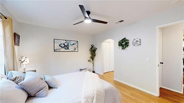 8535 Creekside Pl, Rancho Cucamonga, CA 91730 - bedroom featuring arched walkways, light wood-style floors, baseboards, and ceiling fan