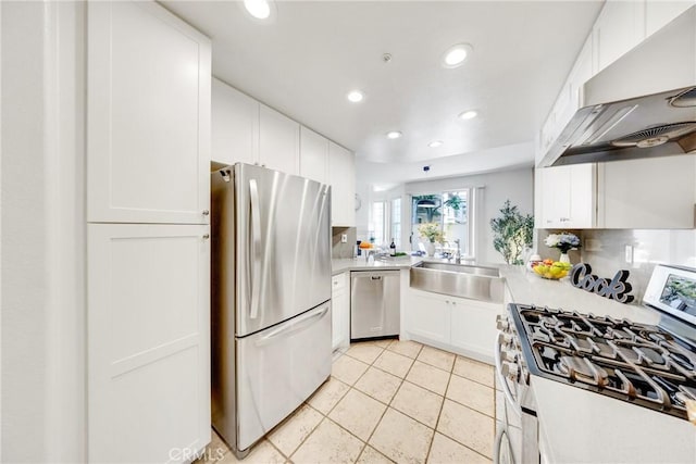 13445 Savanna, Tustin, CA 92782 - kitchen with stainless steel appliances, wall chimney exhaust hood, recessed lighting, white cabinetry, and a sink