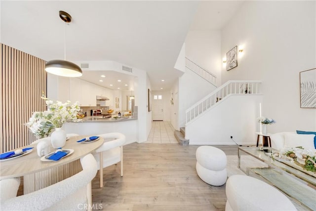 13445 Savanna, Tustin, CA 92782 - living room with light wood finished floors, stairs, a high ceiling, and recessed lighting