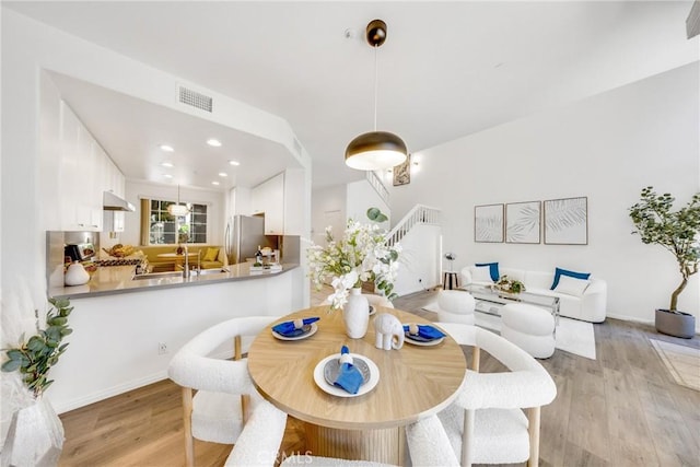 13445 Savanna, Tustin, CA 92782 - dining area with stairs, light wood finished floors, recessed lighting, and baseboards