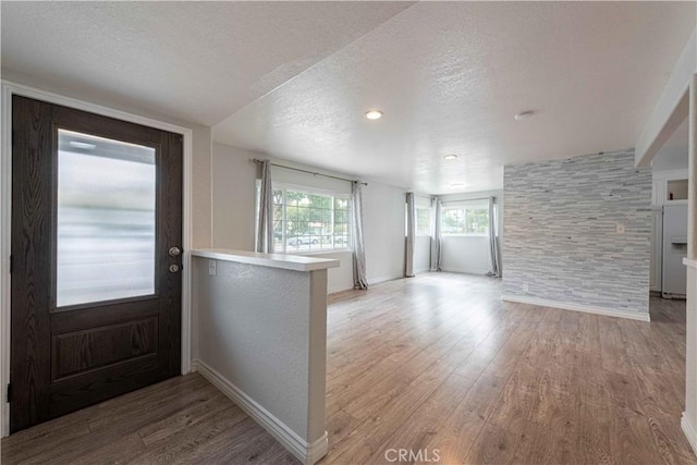 4408 Walnut Ave, Simi Valley, CA 93063 - entrance foyer with light wood-style flooring, a textured ceiling, and baseboards