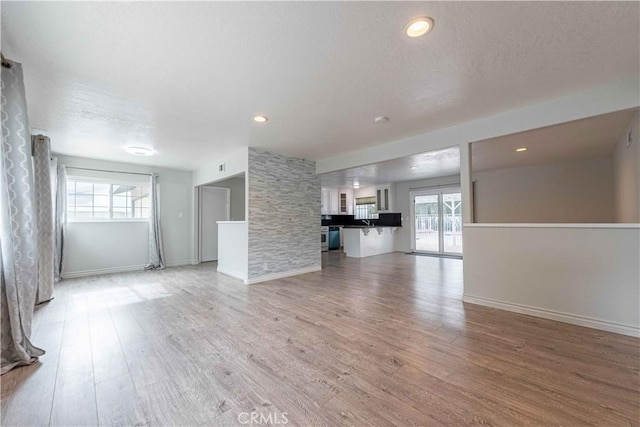 4408 Walnut Ave, Simi Valley, CA 93063 - unfurnished living room with plenty of natural light, light wood-style floors, and baseboards