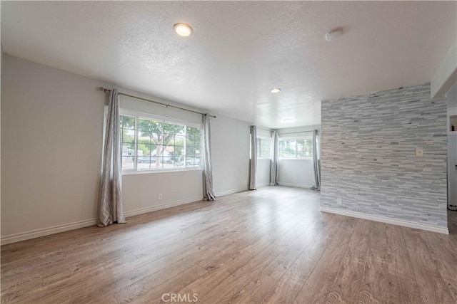 4408 Walnut Ave, Simi Valley, CA 93063 - spare room featuring healthy amount of natural light, light wood-style flooring, baseboards, and a textured ceiling