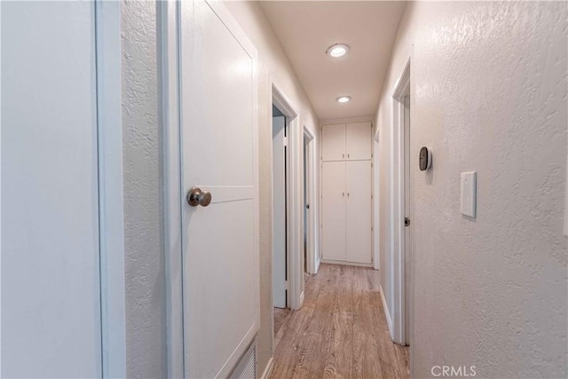 4408 Walnut Ave, Simi Valley, CA 93063 - hallway featuring a textured wall, recessed lighting, light wood-style flooring, and baseboards