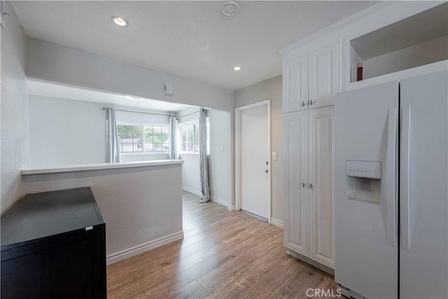 4408 Walnut Ave, Simi Valley, CA 93063 - kitchen with white fridge with ice dispenser, light wood-style floors, white cabinets, baseboards, and recessed lighting