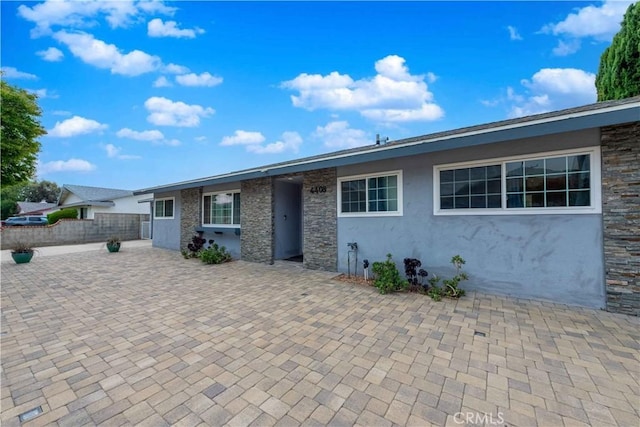 4408 Walnut Ave, Simi Valley, CA 93063 - ranch-style home with stucco siding, a patio area, and stone siding