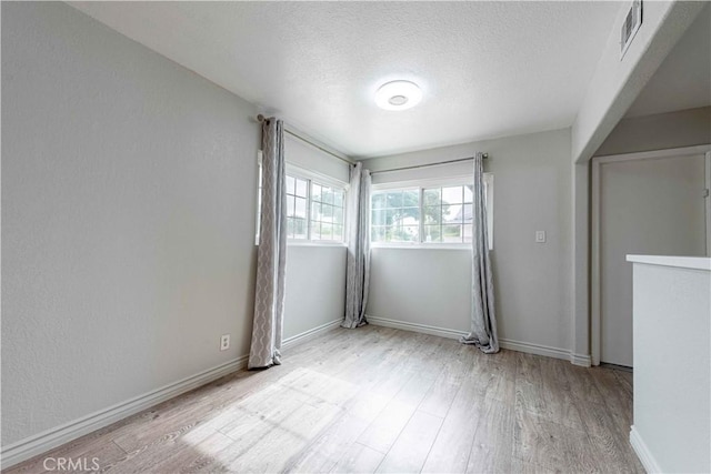 4408 Walnut Ave, Simi Valley, CA 93063 - spare room with light wood-type flooring, a textured ceiling, and baseboards