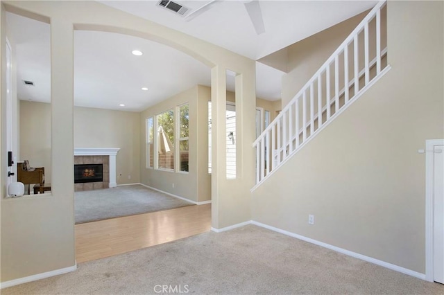 2 Hydrangea St, Ladera Ranch, CA 92694 - entryway with carpet flooring, baseboards, arched walkways, a tiled fireplace, and recessed lighting