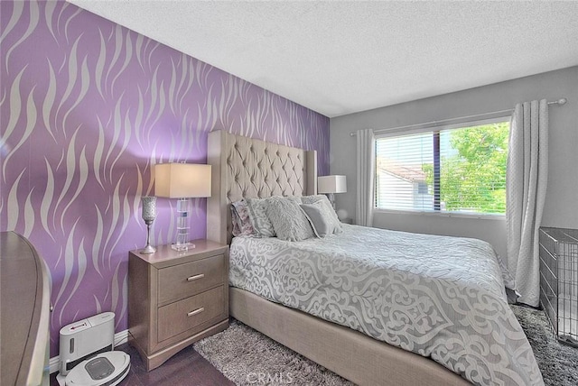 44 Carriage Way Unit 108, Pomona, CA 91766 - bedroom with a textured ceiling, wallpapered walls, an accent wall, carpet floors, and baseboards