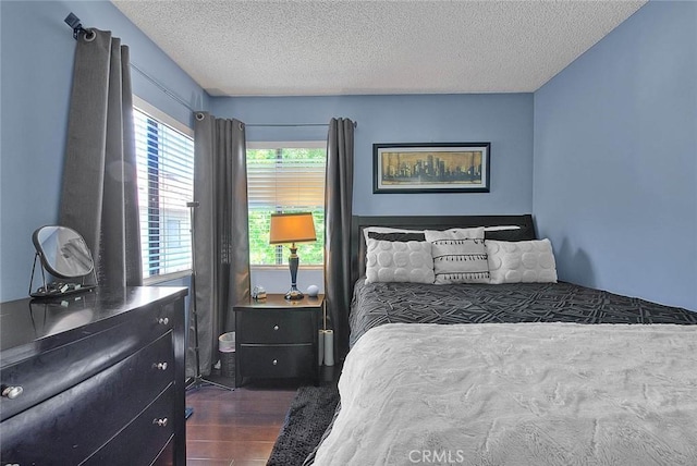 44 Carriage Way Unit 108, Pomona, CA 91766 - bedroom with dark wood finished floors and a textured ceiling