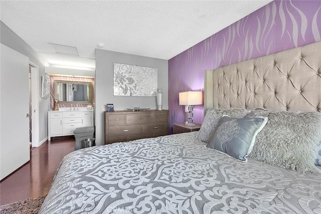 44 Carriage Way Unit 108, Pomona, CA 91766 - bedroom with attic access, a textured ceiling, wood finished floors, baseboards, and an accent wall