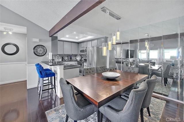 44 Carriage Way Unit 108, Pomona, CA 91766 - dining room featuring a textured ceiling, dark wood-style flooring, and vaulted ceiling