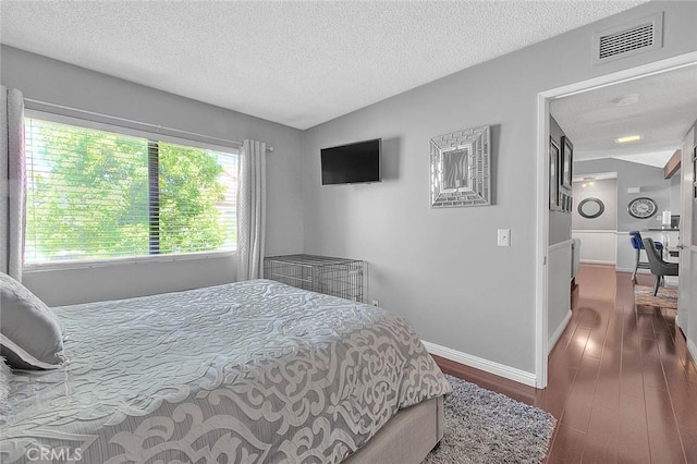 44 Carriage Way Unit 108, Pomona, CA 91766 - bedroom with dark wood-type flooring, a textured ceiling, baseboards, and vaulted ceiling