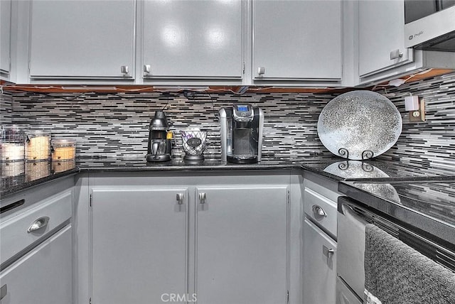 44 Carriage Way Unit 108, Pomona, CA 91766 - kitchen featuring stainless steel microwave, backsplash, white cabinetry, and electric range oven