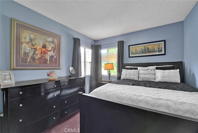 44 Carriage Way Unit 108, Pomona, CA 91766 - bedroom featuring dark colored carpet and a textured ceiling