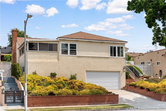 2917 W Hellman Ave, Alhambra, CA 91803 - view of side of property with stairs, driveway, stucco siding, and a garage