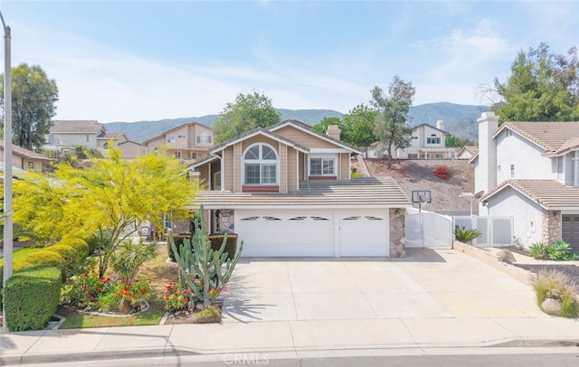 13179 Lone Stallion Ln, Corona, CA 92883 - traditional home with a garage, a mountain view, driveway, a gate, and a residential view
