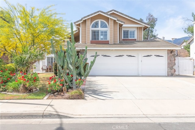 13179 Lone Stallion Ln, Corona, CA 92883 - traditional home with a garage, concrete driveway, and a gate