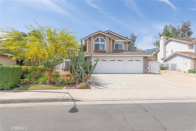 13179 Lone Stallion Ln, Corona, CA 92883 - traditional-style house featuring driveway, a garage, and stone siding