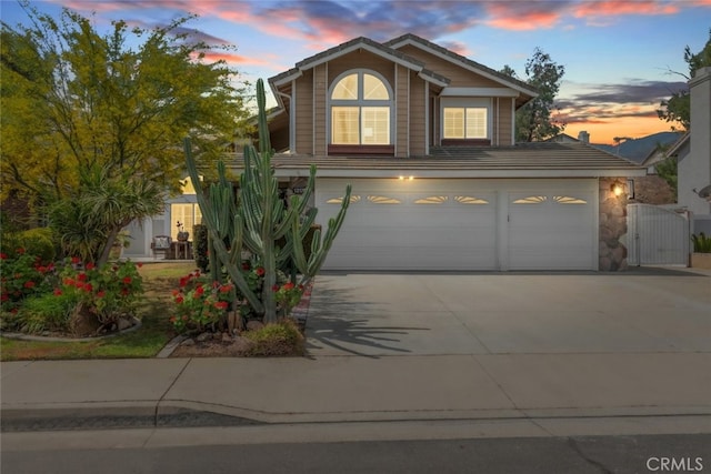 13179 Lone Stallion Ln, Corona, CA 92883 - view of front of property with an attached garage, driveway, a gate, and stone siding