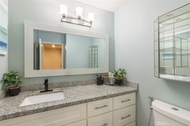 13179 Lone Stallion Ln, Corona, CA 92883 - bathroom with toilet, vanity, and a textured wall