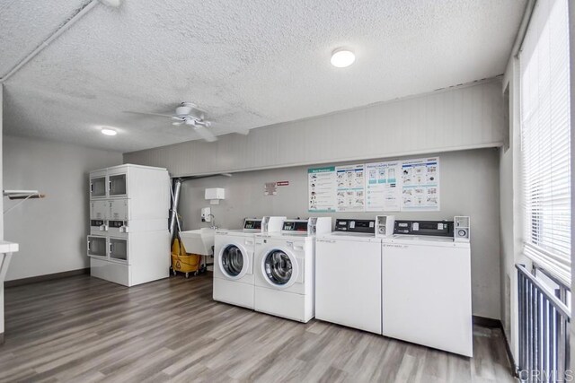 6930 Hyde Park Dr Unit 218, San Diego, CA 92119 - community laundry with stacked washer / drying machine, separate washer and dryer, wood finished floors, a ceiling fan, and a textured ceiling