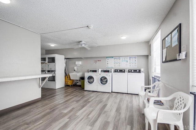 6930 Hyde Park Dr Unit 218, San Diego, CA 92119 - community laundry featuring washer and clothes dryer, a textured ceiling, light wood-type flooring, and a ceiling fan