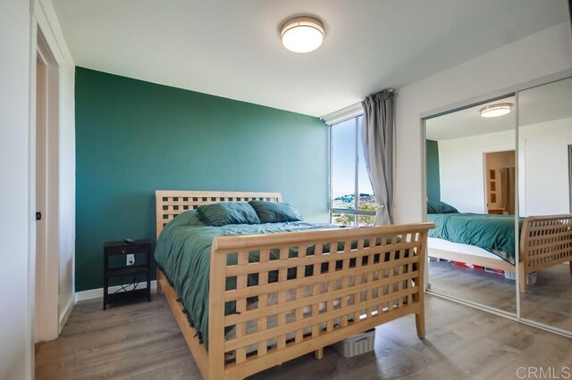 6930 Hyde Park Dr Unit 218, San Diego, CA 92119 - bedroom featuring wood finished floors and baseboards