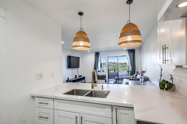 6930 Hyde Park Dr Unit 218, San Diego, CA 92119 - kitchen featuring a sink, open floor plan, white cabinetry, pendant lighting, and recessed lighting