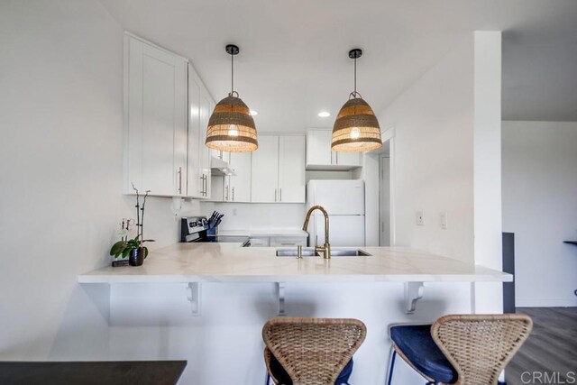 6930 Hyde Park Dr Unit 218, San Diego, CA 92119 - kitchen with stainless steel range oven, freestanding refrigerator, a peninsula, a sink, and light countertops