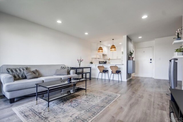 6930 Hyde Park Dr Unit 218, San Diego, CA 92119 - living room with recessed lighting, light wood-style floors, and baseboards