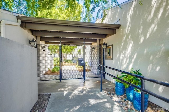 6930 Hyde Park Dr Unit 218, San Diego, CA 92119 - view of exterior entry with stucco siding and a gate